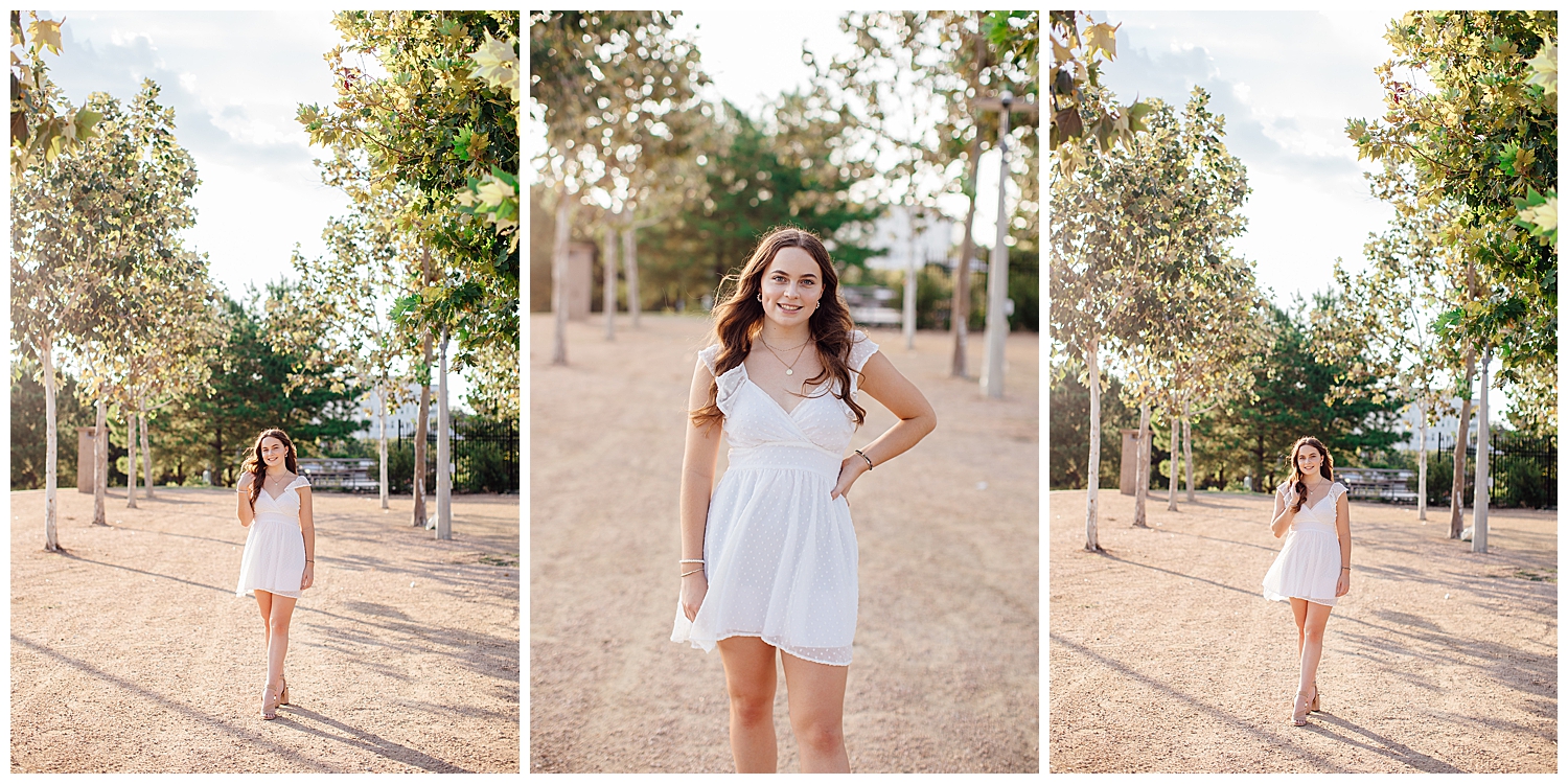 high school girl in white dress walking between trees for Houston outdoor senior photos