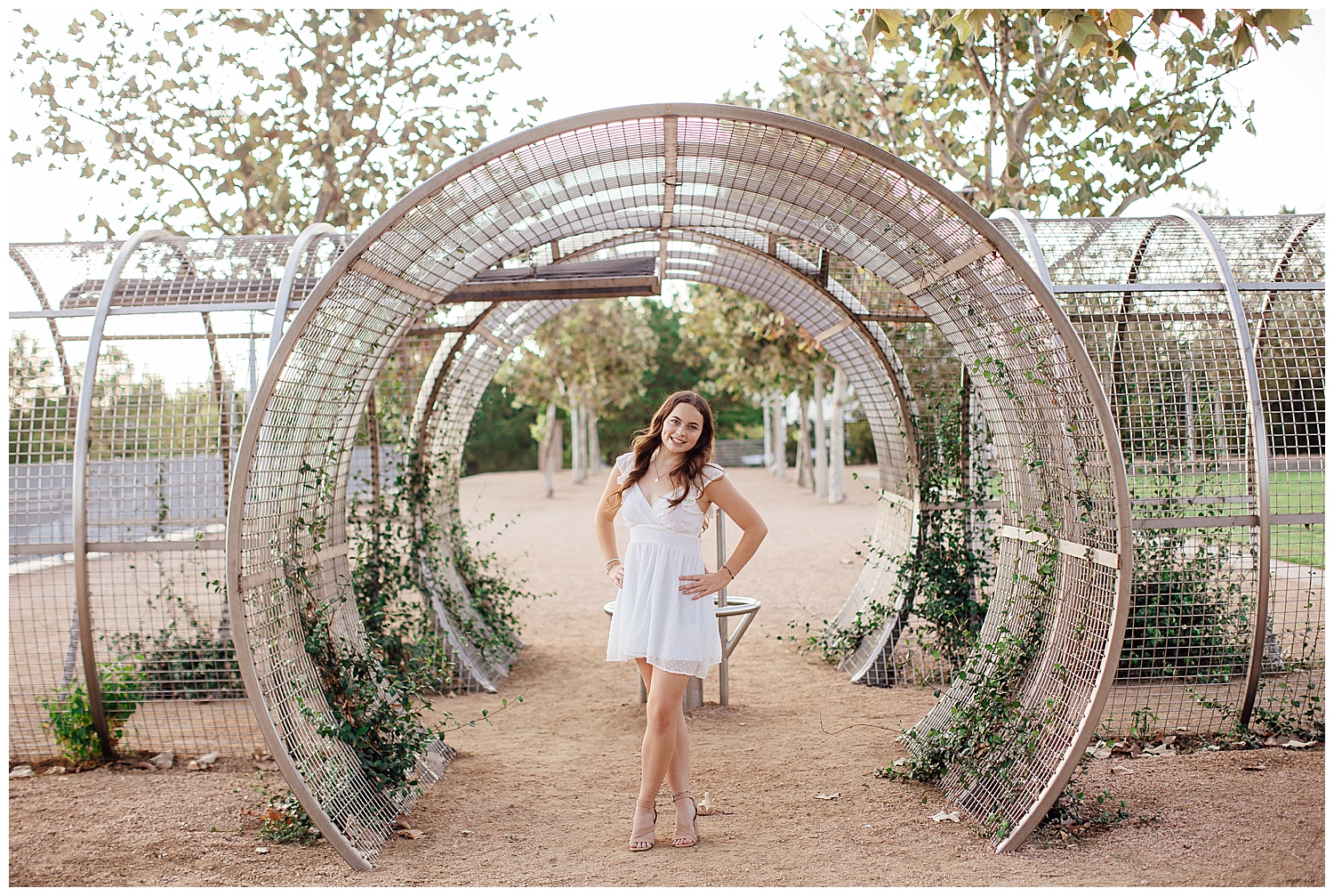 Houston outdoor senior session with girl in white dress standing at Sabine Street park