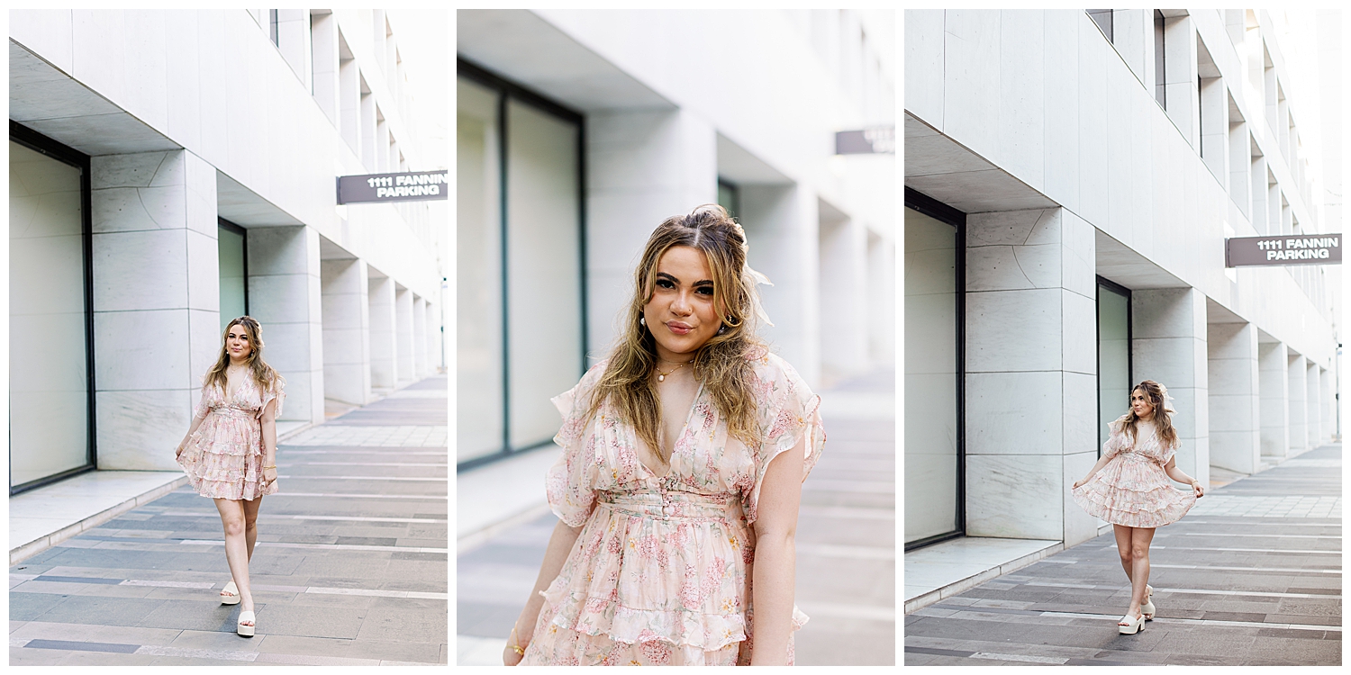 high school senior girl in floral dress walking in front of white wall Houston downtown senior session