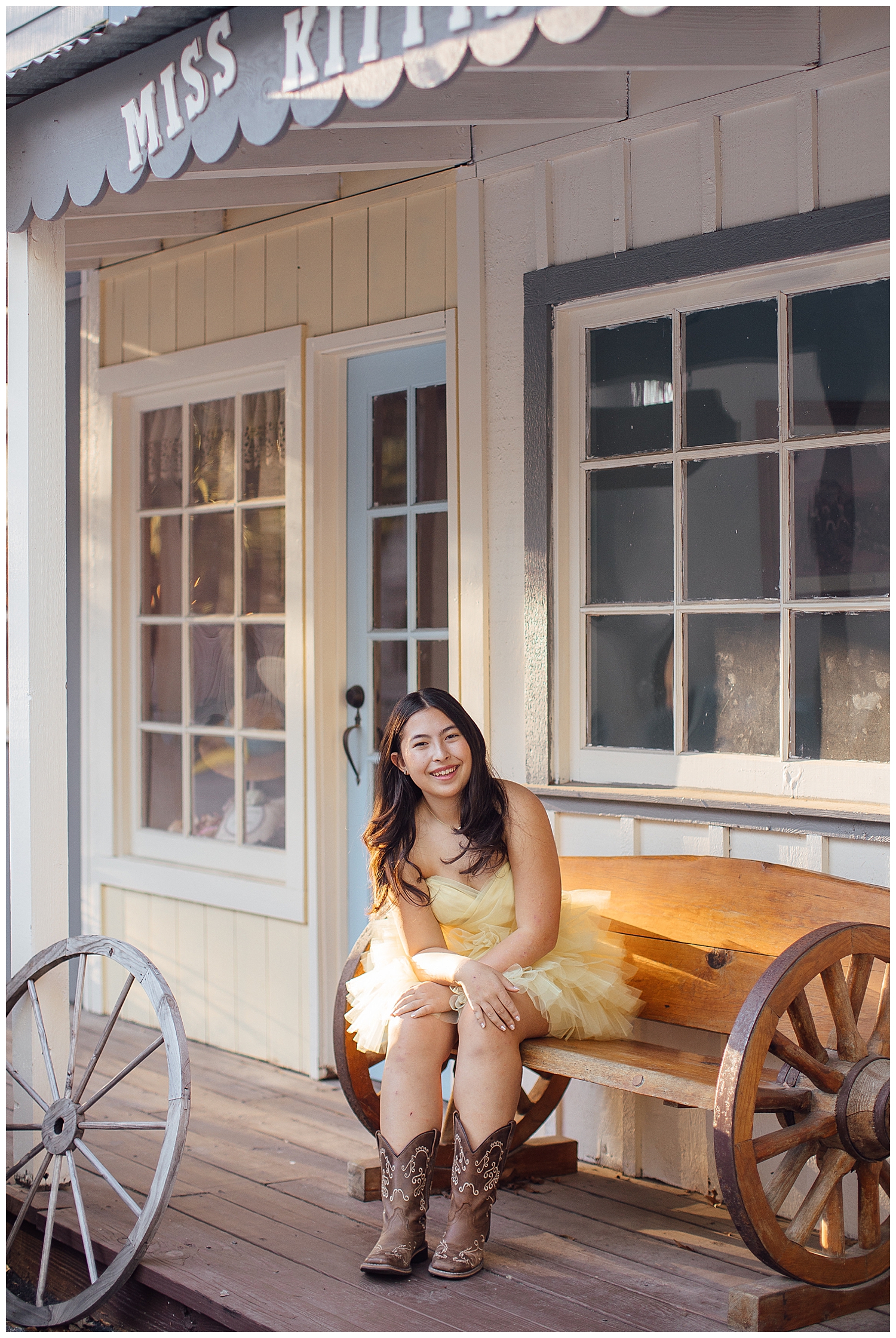high school senior girl sitting on a western bench at Cy Hope for Cypress outdoor senior photographer