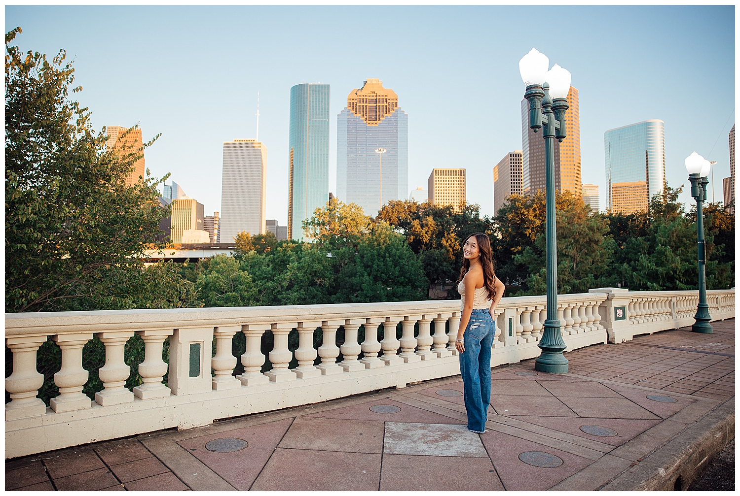 fun senior pictures Houston downtown skyline senior girl in denim jeans