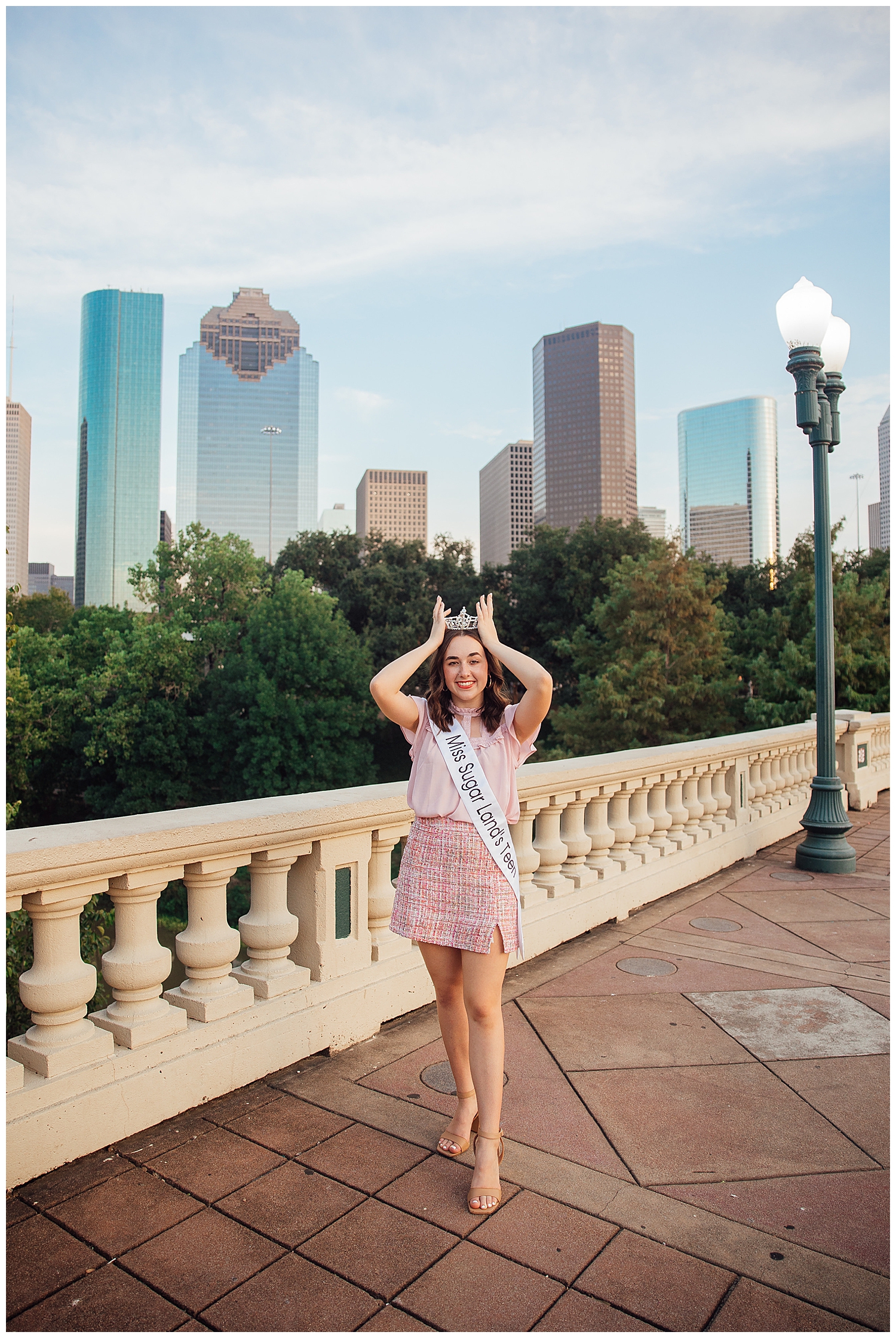 MIss Sugar Land Teen at Houston Skyline Senior Photos holding crown on head with her hands