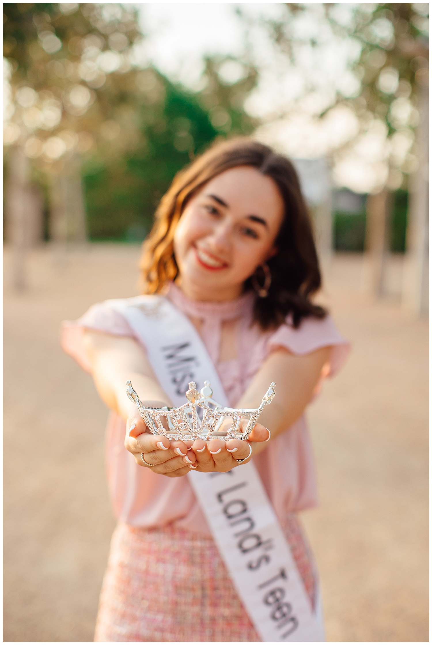 close up image of Miss Sugar Land Teen crown held by houston senior outdoors