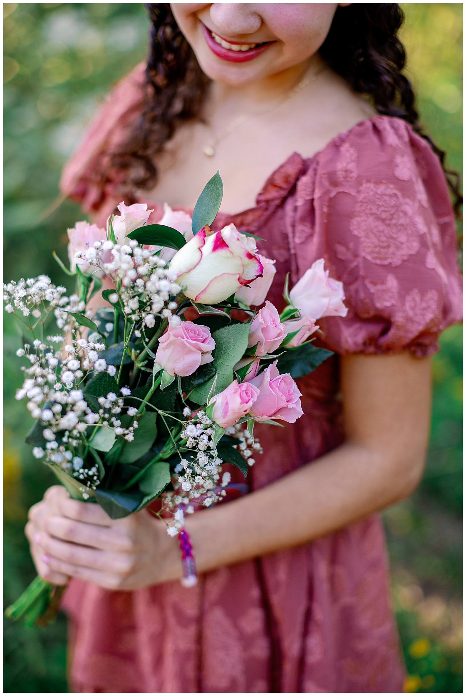 Houston senior pictures with flowers that are pink and white being held by a girl