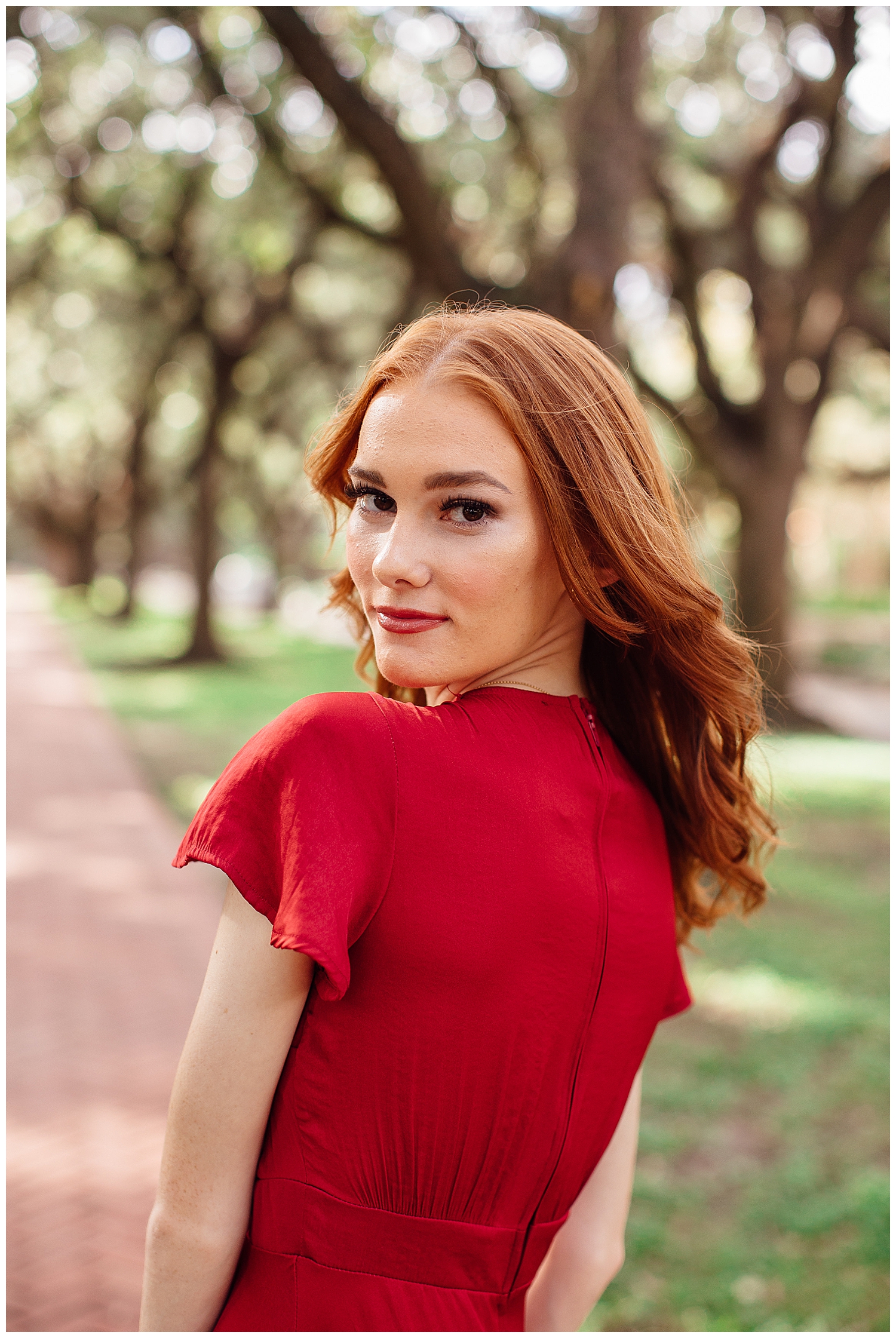 close up image of girl with red hair wearing red dress outdoor Houston