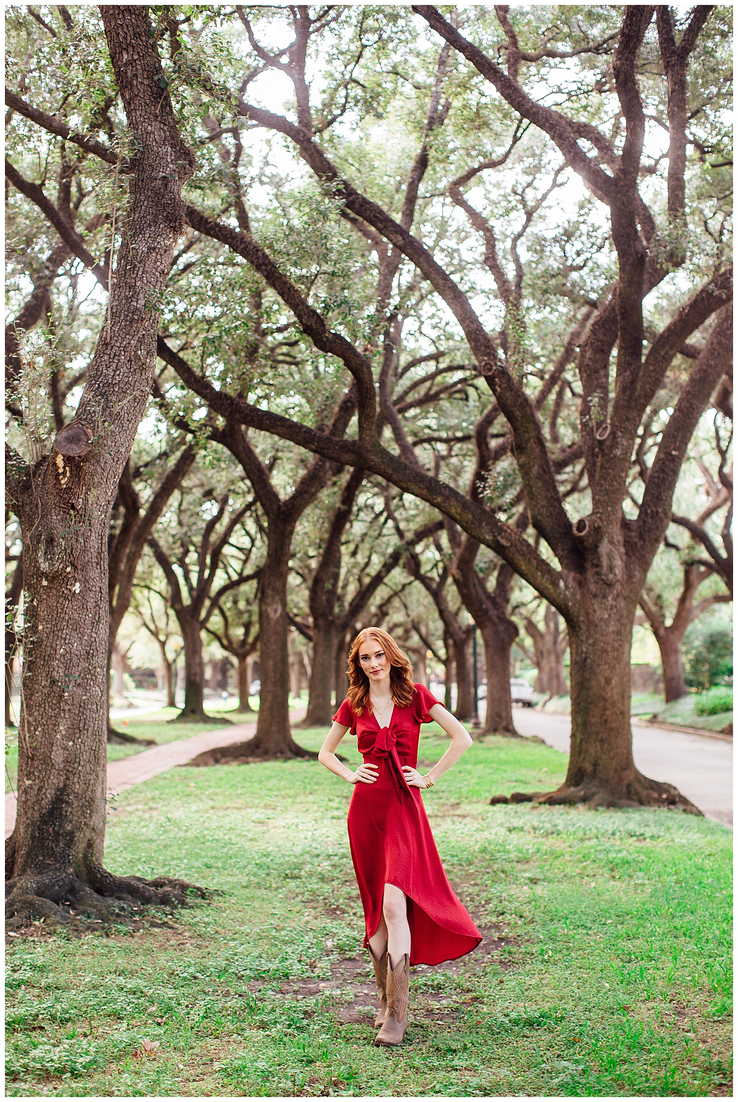 girl in red dress standing with hand son hip in front in Houston tree line
