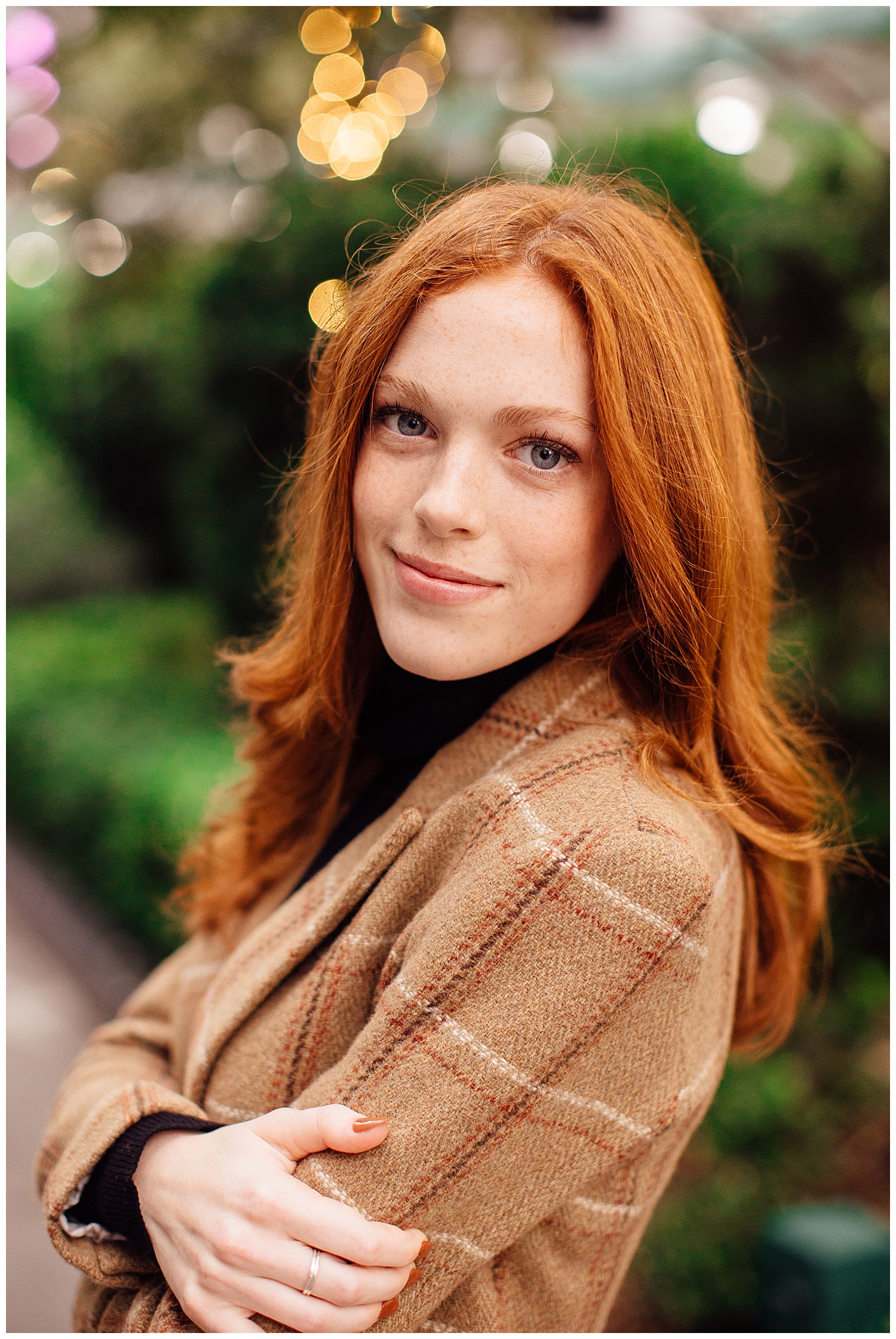 senior girl with red hair smiling at camera in brown tweed jackeet