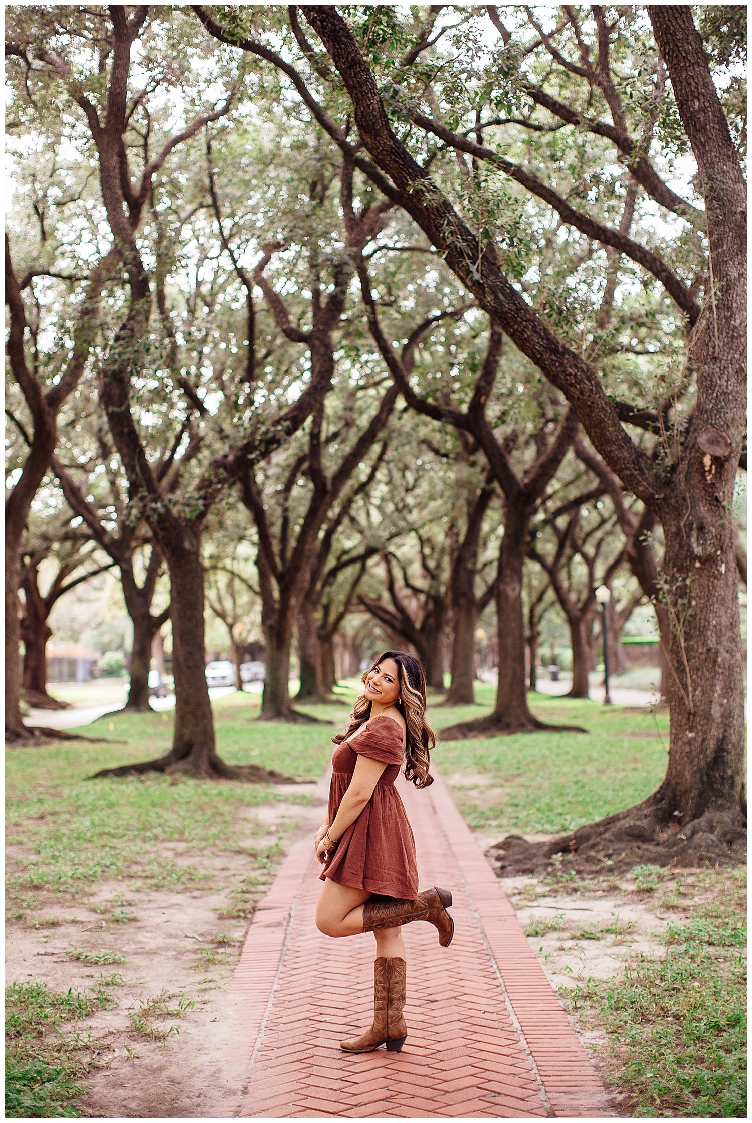 high school senior girl in rust sundress standing in tree line Houston