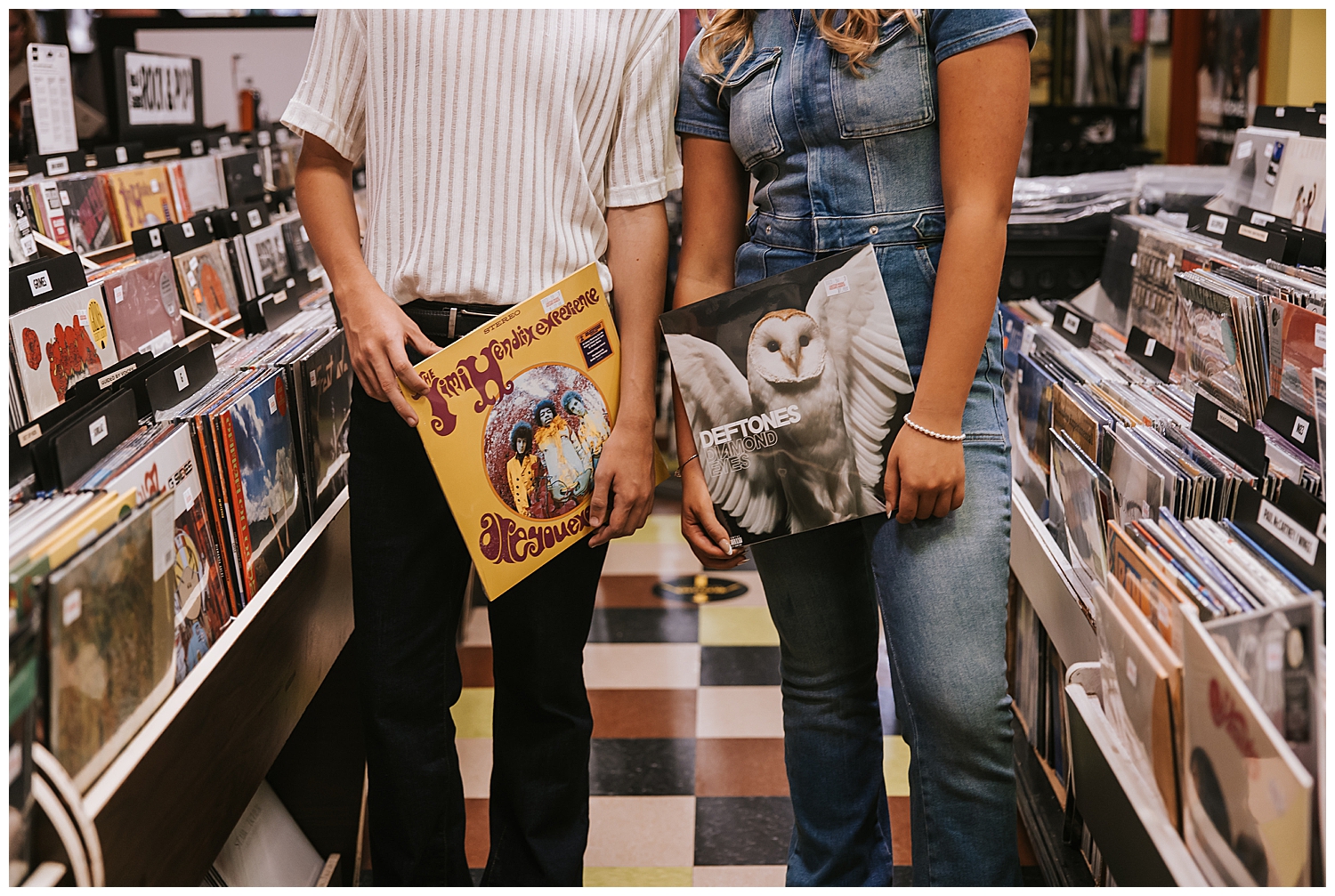 high school senior girl and boy twins holding record albums inside Houston record store