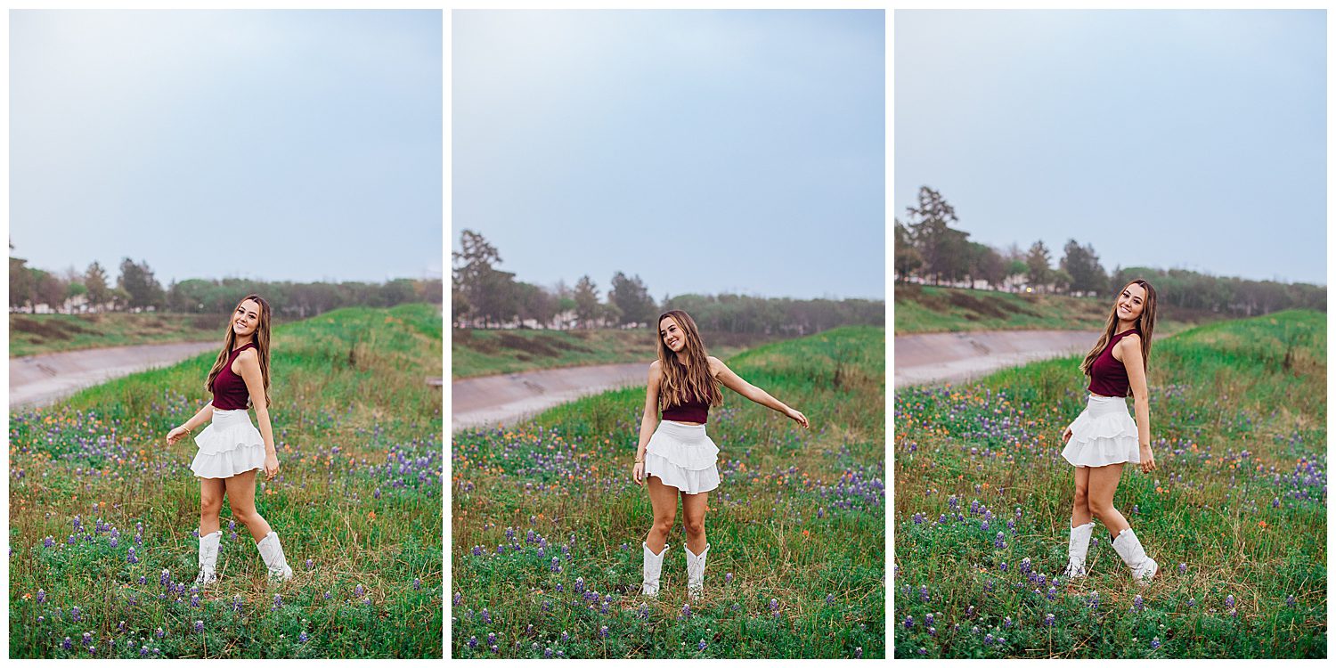 high school senior girl in white skirt and Aggie shirt with white boots standing in bluebonnets