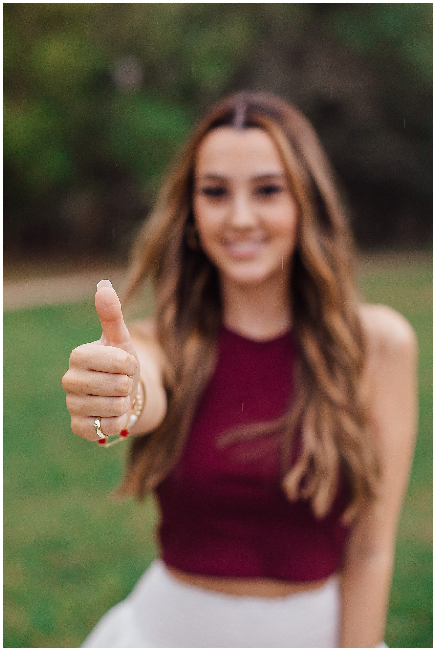 high school senior girl with aggie hand sign smiling